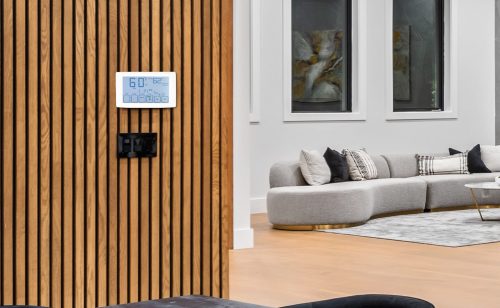 cheerful businesspeople laughing while standing under air condit cheerful businesspeople laughing while standing under air conditioner in office